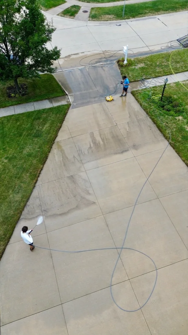 Aerial view of a cleaned driveway and home exterior