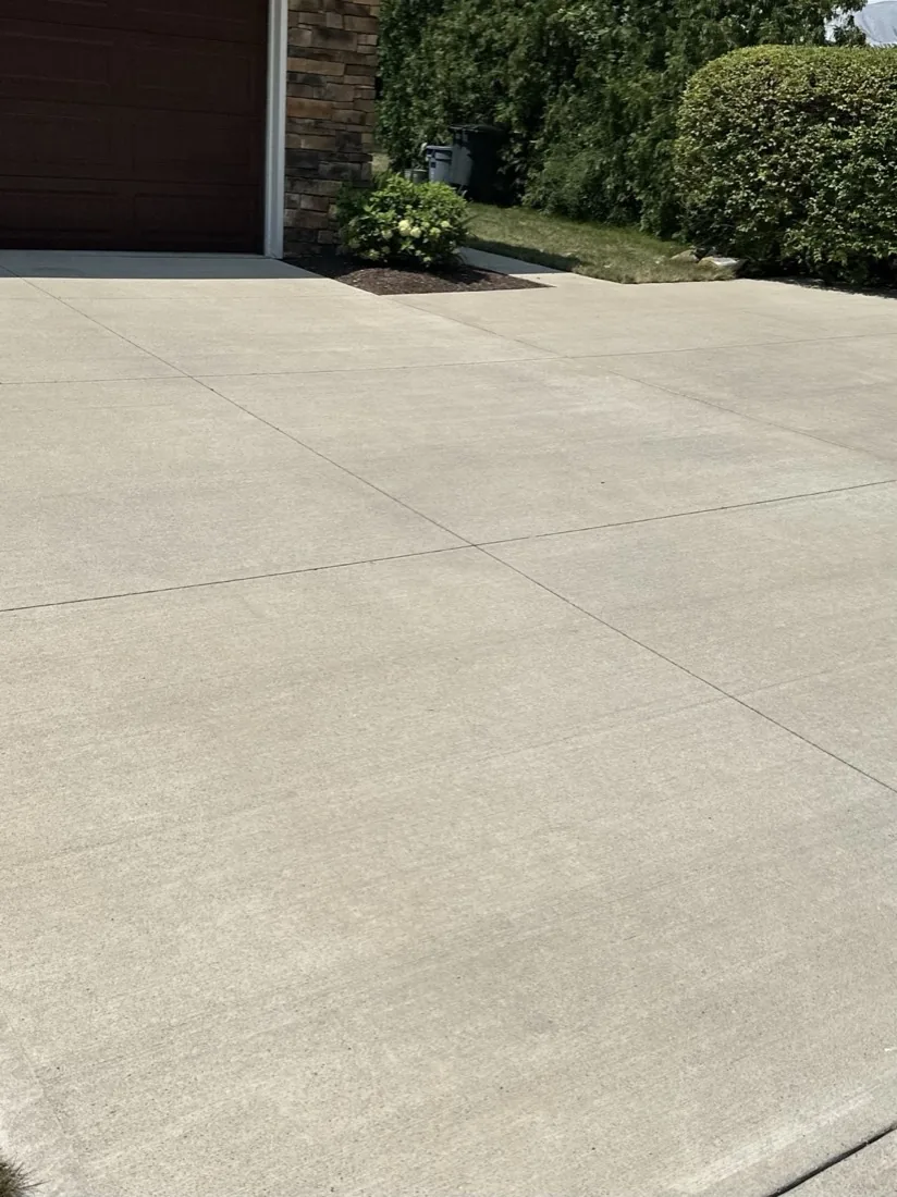 Clean concrete driveway after pressure washing