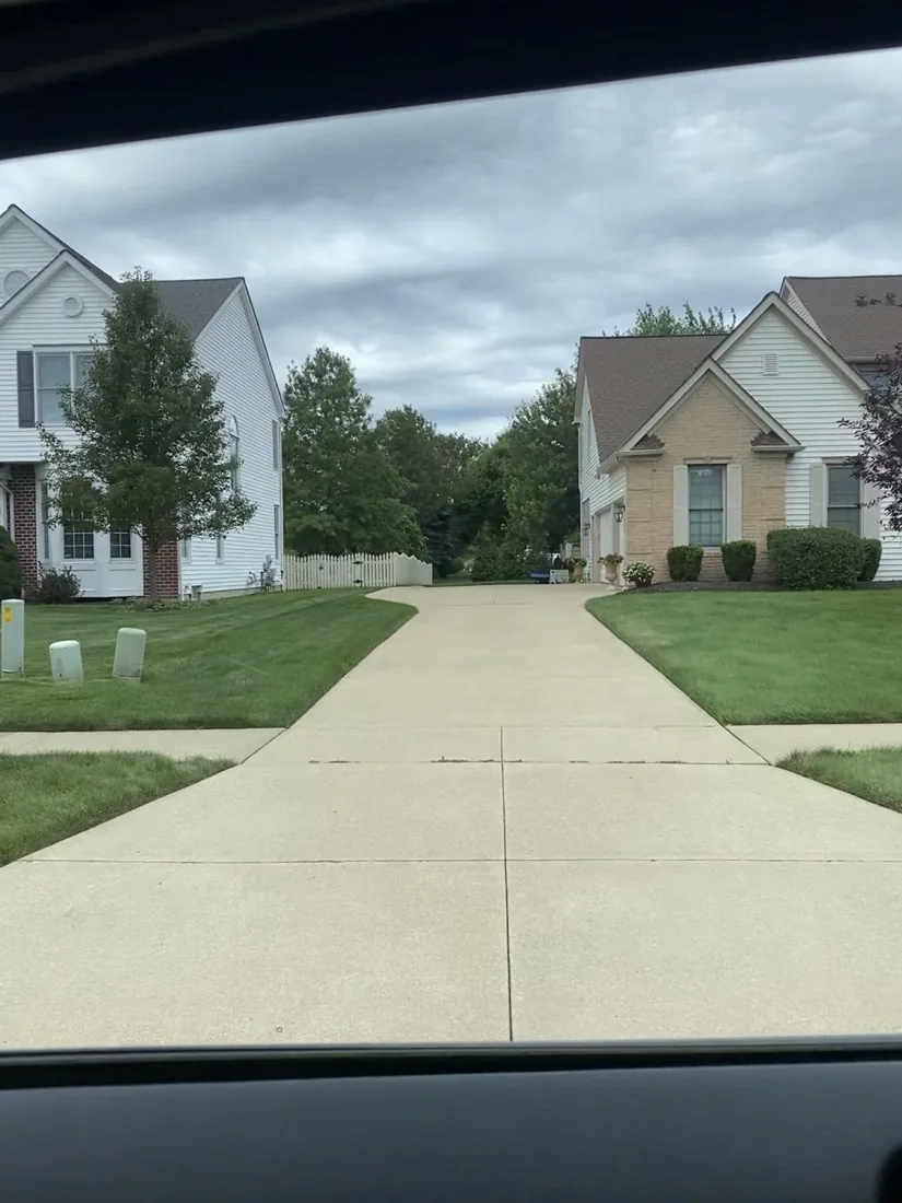 Clean concrete driveway and garage after pressure washing
