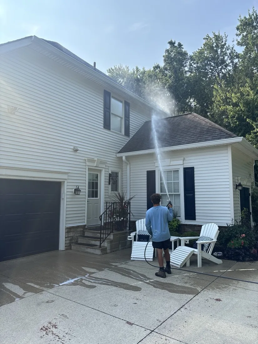 Soft washing beside the front entry and porch columns