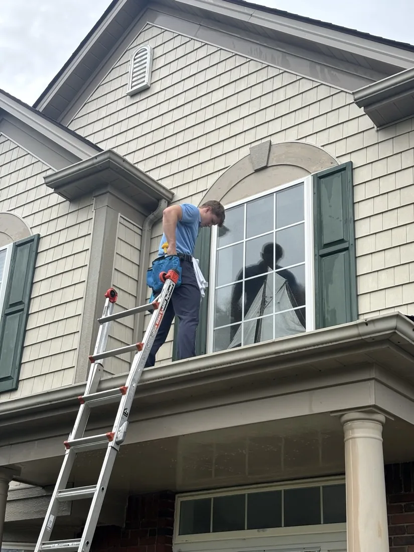 Two technicians on a window cleaning job at the front elevation