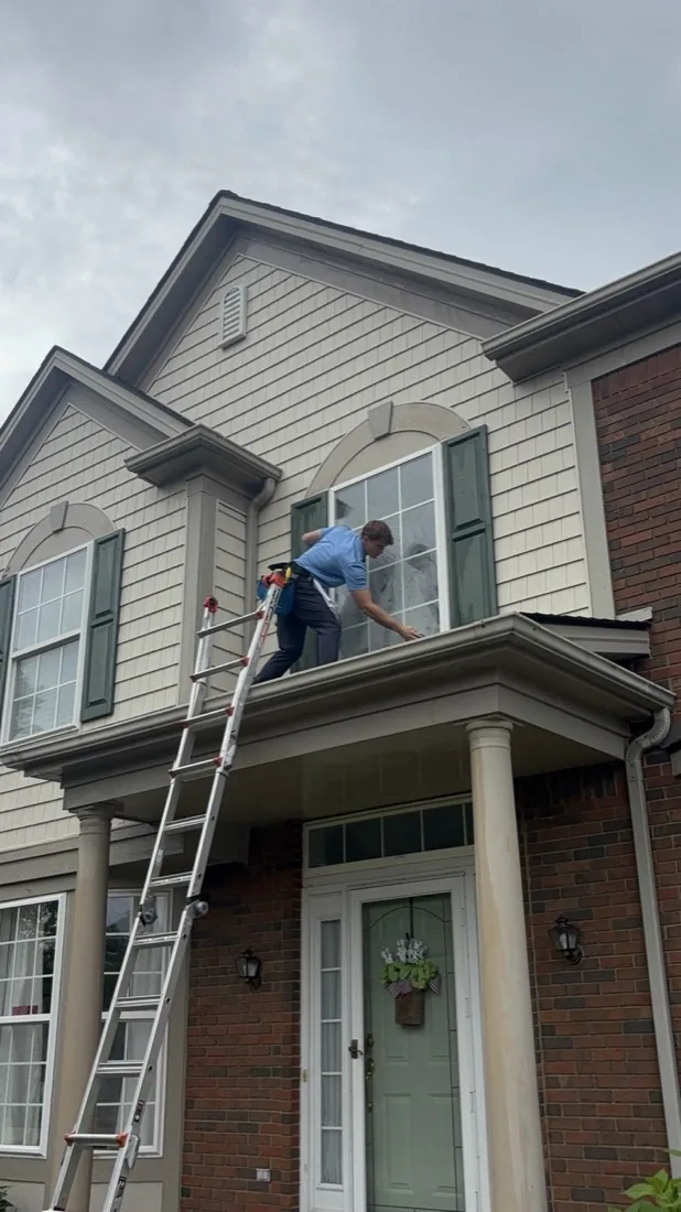Cleaned upper windows across the front gable