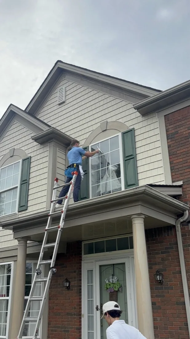 Working along the top edge of an arched upper window