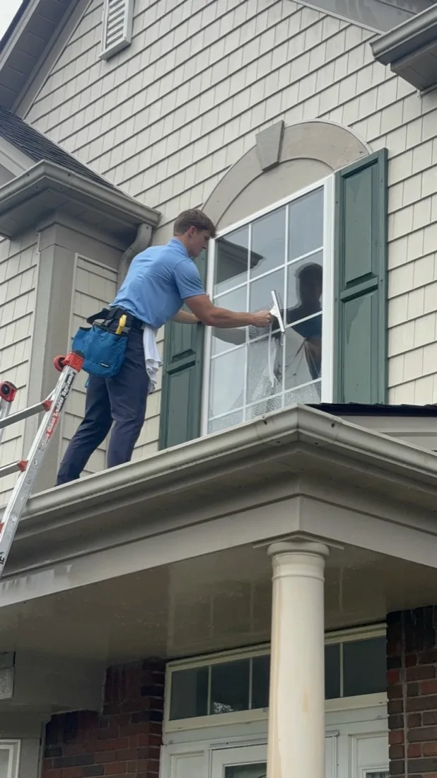 Detail of a squeegee pass across an upper window pane